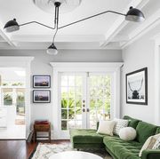 feng shui living room, light and airy living room with light gray walls and green velvet couch