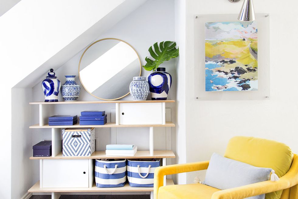 feng shui living room, bright yellow chair with blue accents and wall art