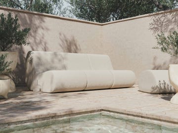 a group of white modular armchairs outside