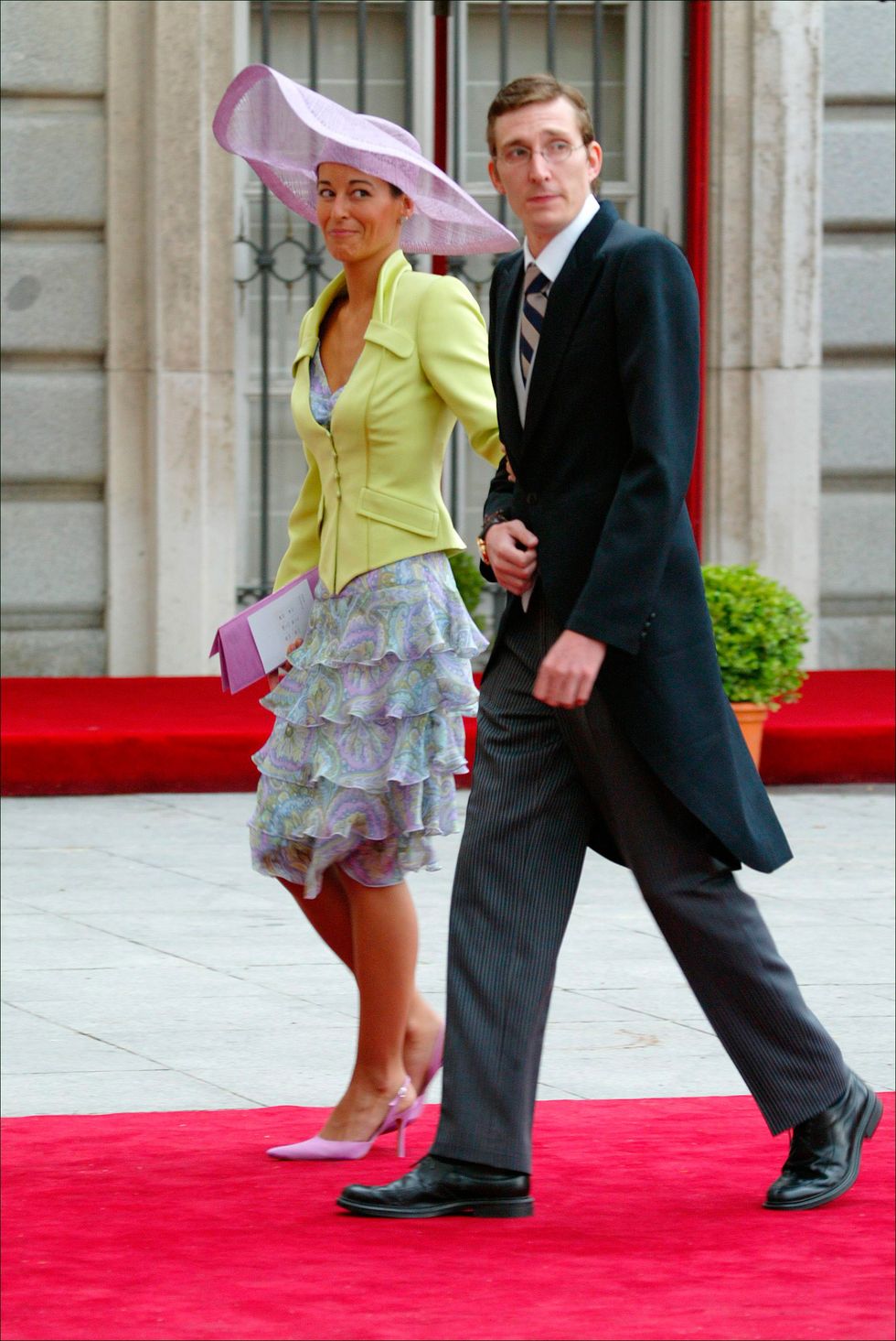 a man and woman walking on a red carpet