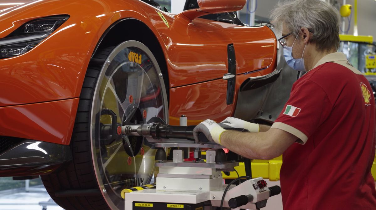 ferrari workers back on the job with social precautions and masks
