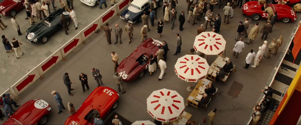 a row of cars going down a crowded street