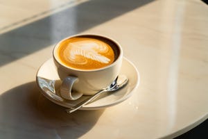 feshly brewed latte coffee on a white table