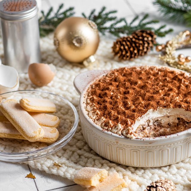 festive christmas dessert tiramisu sponge cake in bright rustic kitchen with golden christmas ornaments