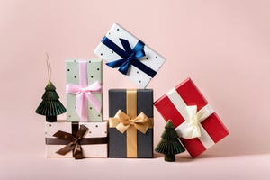 festive christmas new year background colorful gift boxes and holiday decorations on pink background