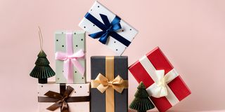 festive christmas new year background colorful gift boxes and holiday decorations on pink background