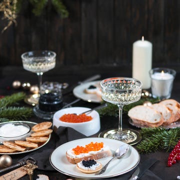 festive christmas table with caviar blinis and champagne