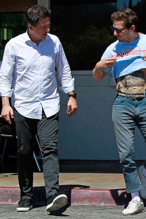 Shia LaBeouf proudly show off his new tattoo and his well built abs to his friend after their lunch date in Beverly Hills.