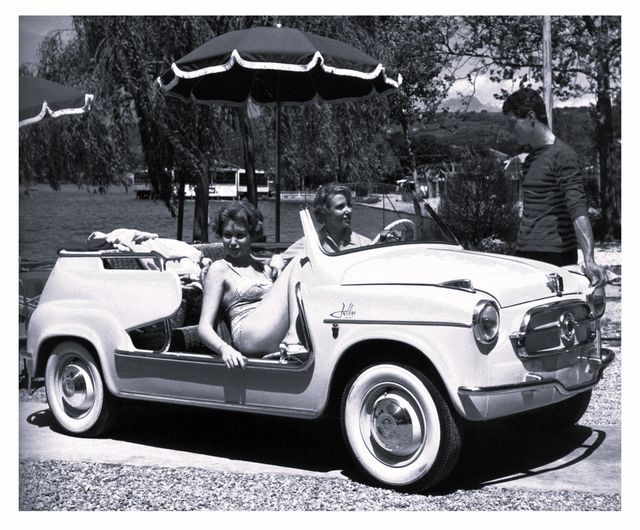 a man and a woman in a convertible car