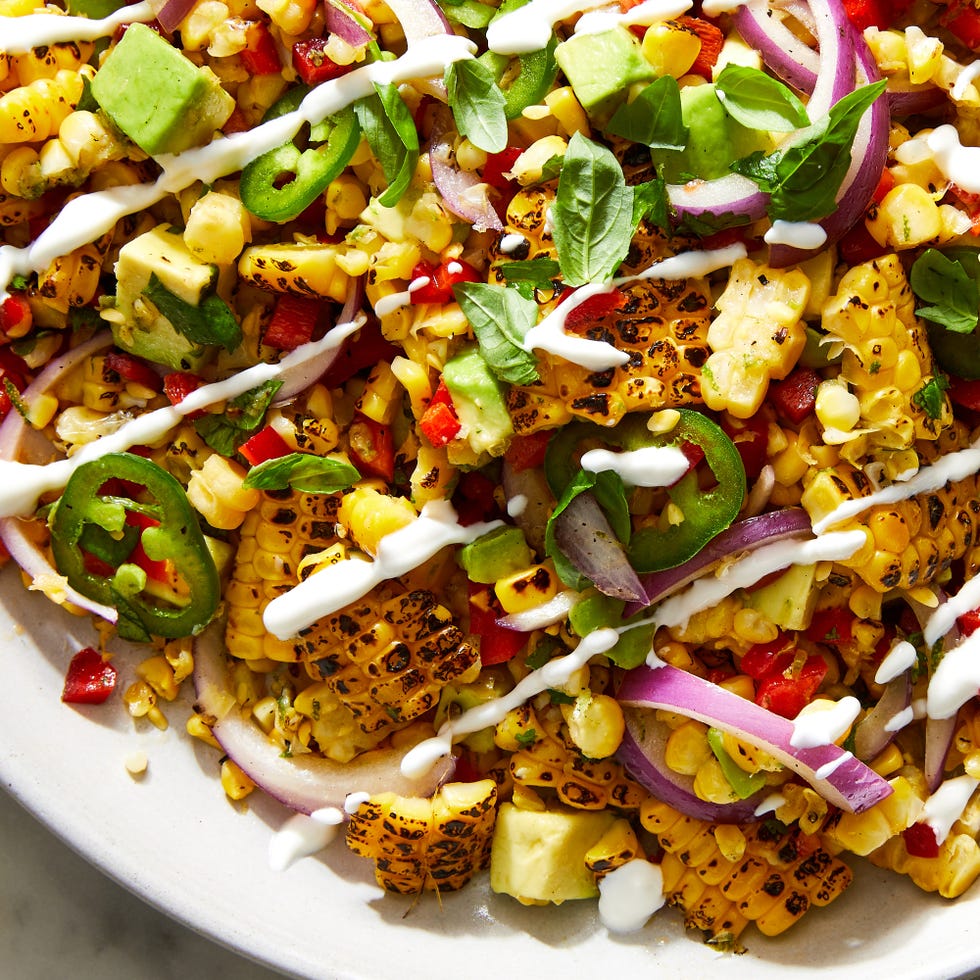 fiesta corn salad topped with crema
