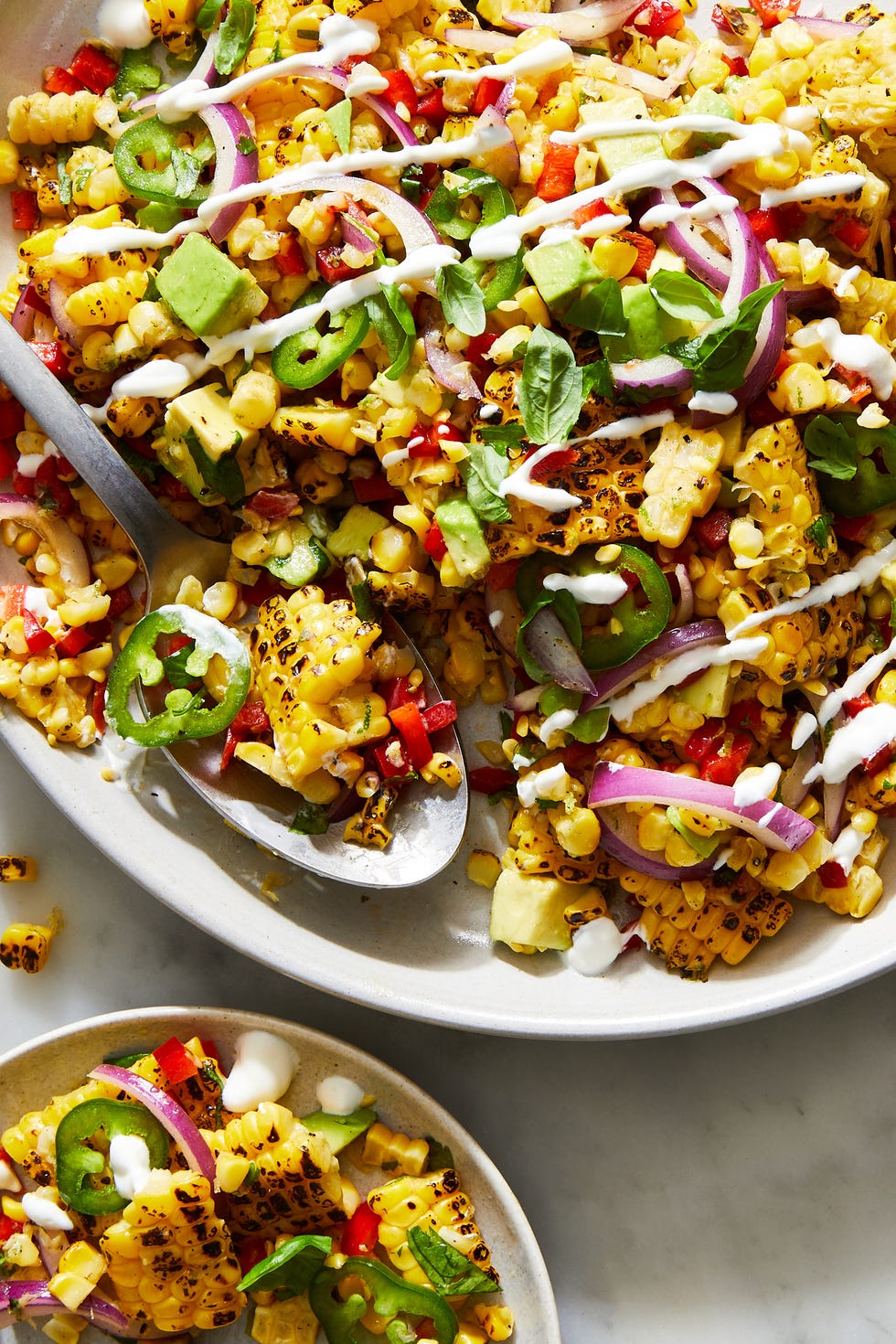 fiesta corn salad topped with crema