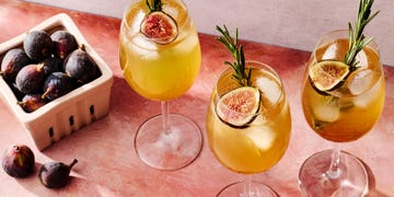figgy spritz cocktail with a fig and rosemary garnish