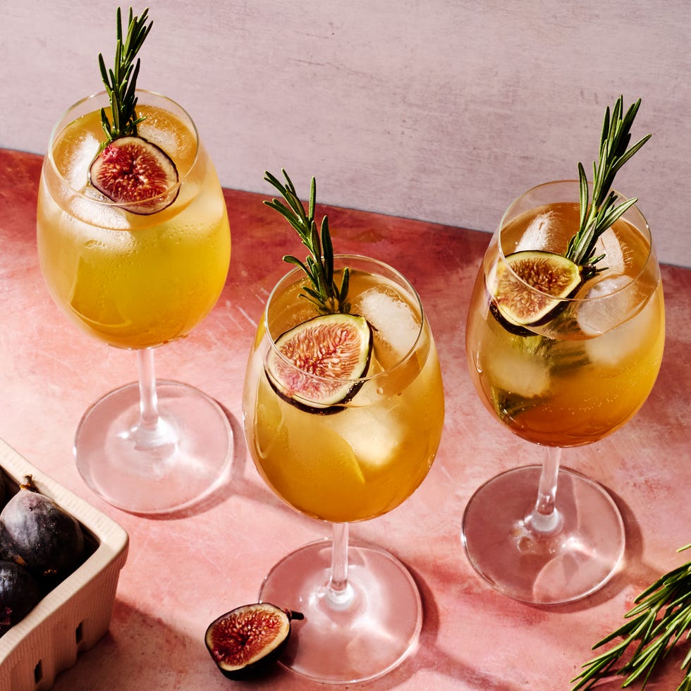 figgy spritz cocktail with a fig and rosemary garnish