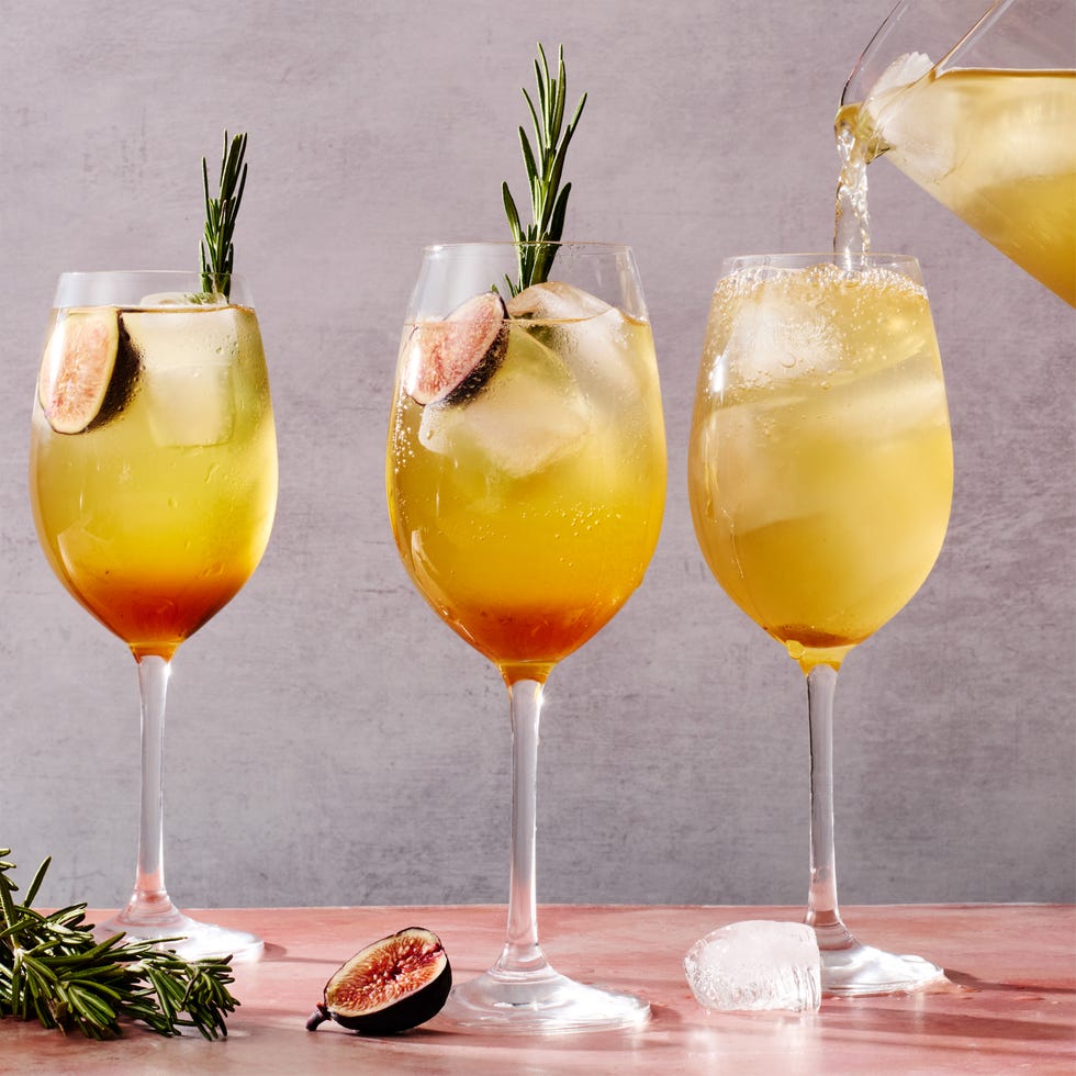 figgy spritz cocktail with a fig and rosemary garnish