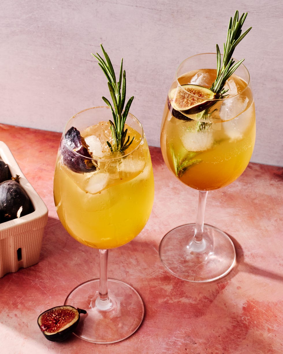 figgy spritz cocktail with a fig and rosemary garnish