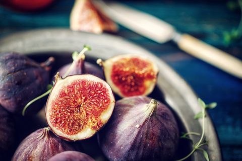 Figs and Sweet Honey on Wooden Background