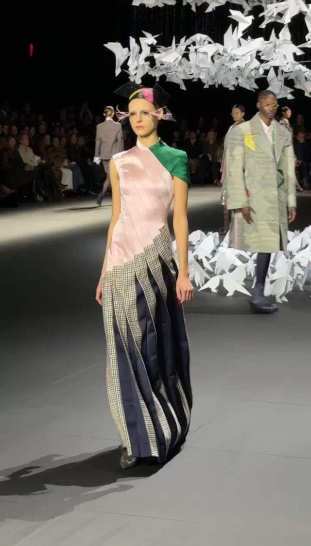 fashion model on runway wearing a unique multitextured dress