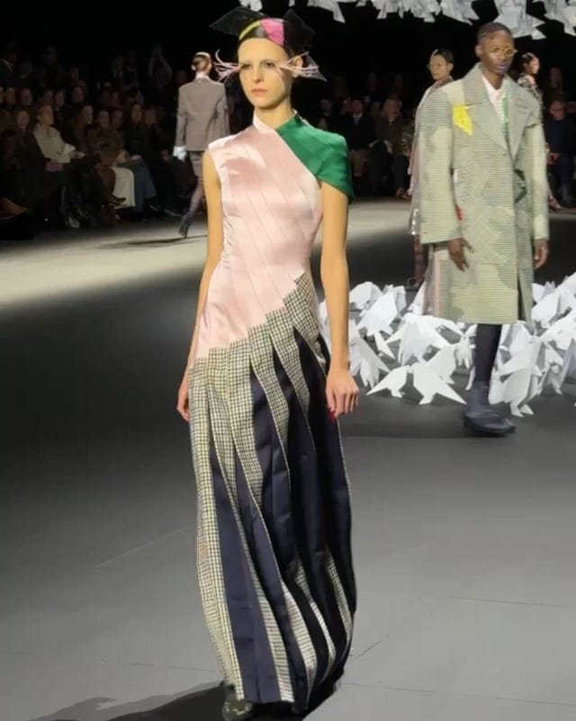 fashion model on runway wearing a unique multitextured dress fashion model on runway wearing a unique multitextured dress