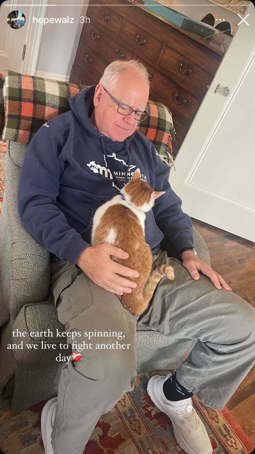 a person sitting comfortably with a cat on their lap, giving a sense of relaxation