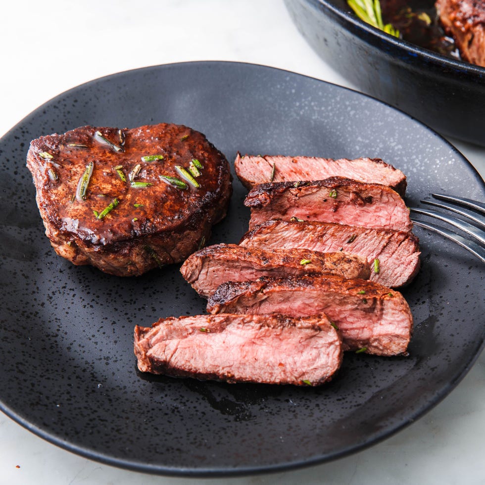 filet mignon sliced and topped with rosemary