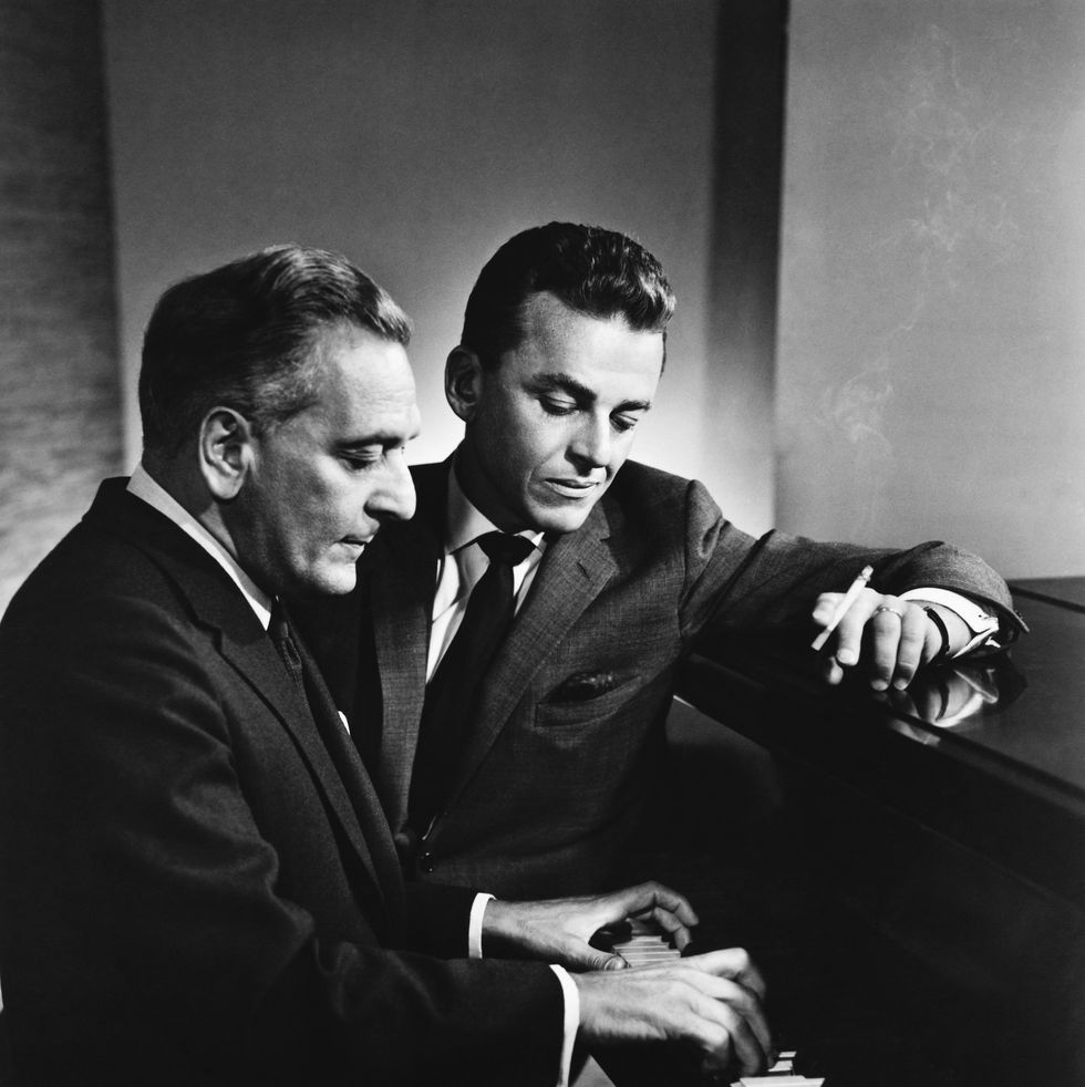film composers frederick loewe (left) and alan jay lerner go over a tune at the piano. (photo by �� john springer collection/corbis/corbis via getty images)