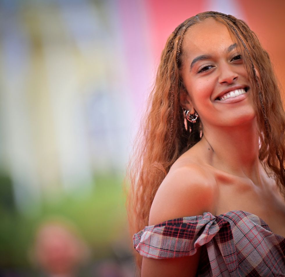 woman smiling in front of a blurred background
