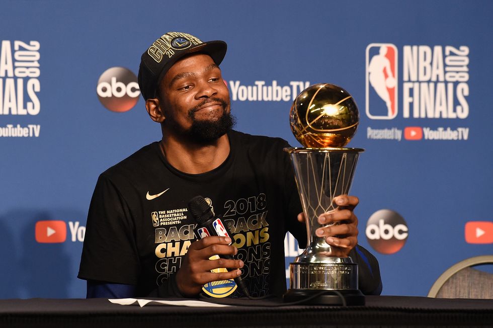 man sitting at a table and holding a trophy
