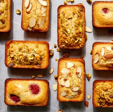 financier cakes with topped with raspberries, pistachios, and almonds