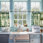 blue kitchen with green patterned cafe curtains
