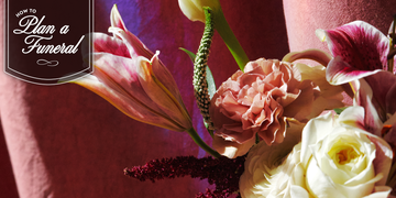 bouquet of lillies and roses with a strobe of light highlighting the petals