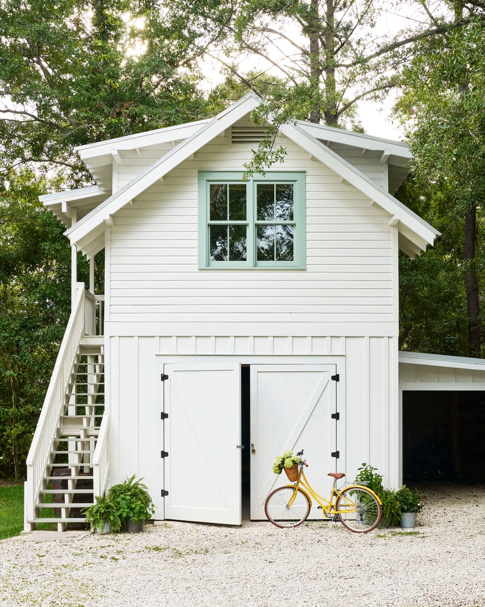 white guest house garage with yellow bike in front