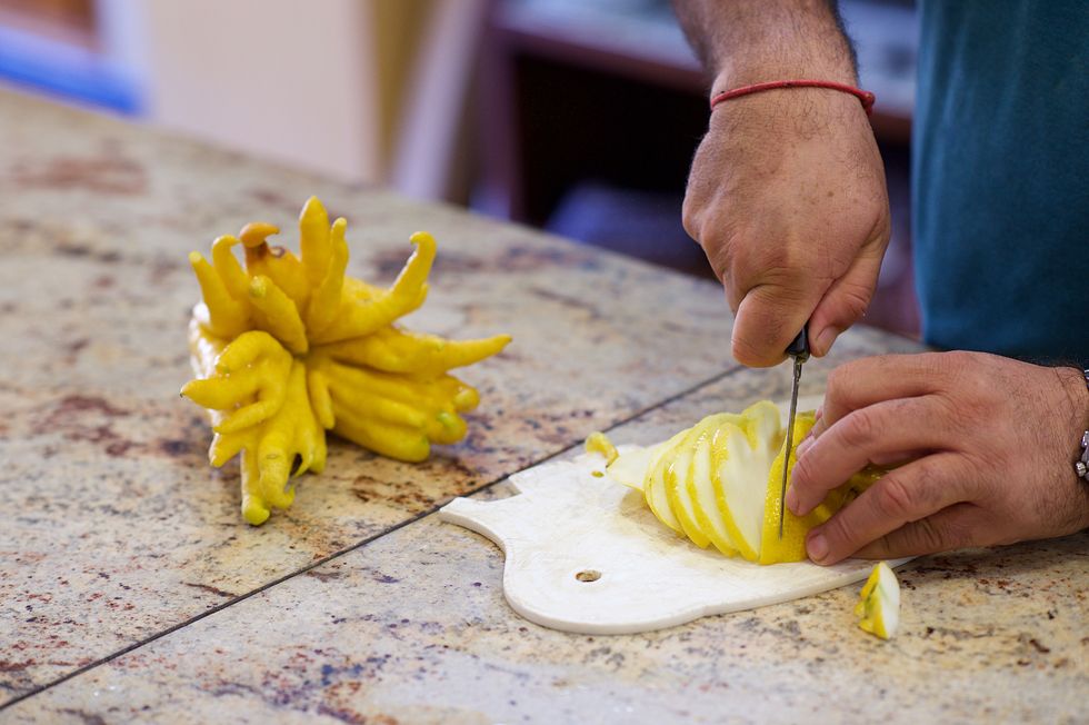 fingered citron buddha's hand being cut in slices