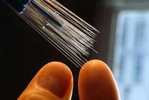 fingers touching optical fibers