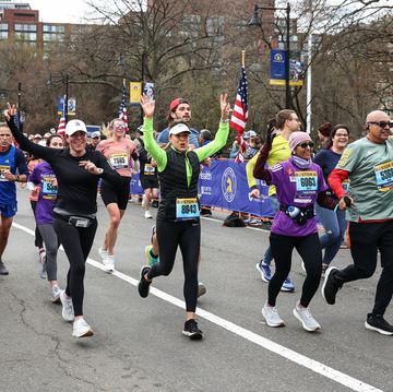 a group of runners cheer during a road race