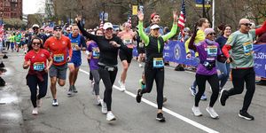 a group of runners cheer during a road race