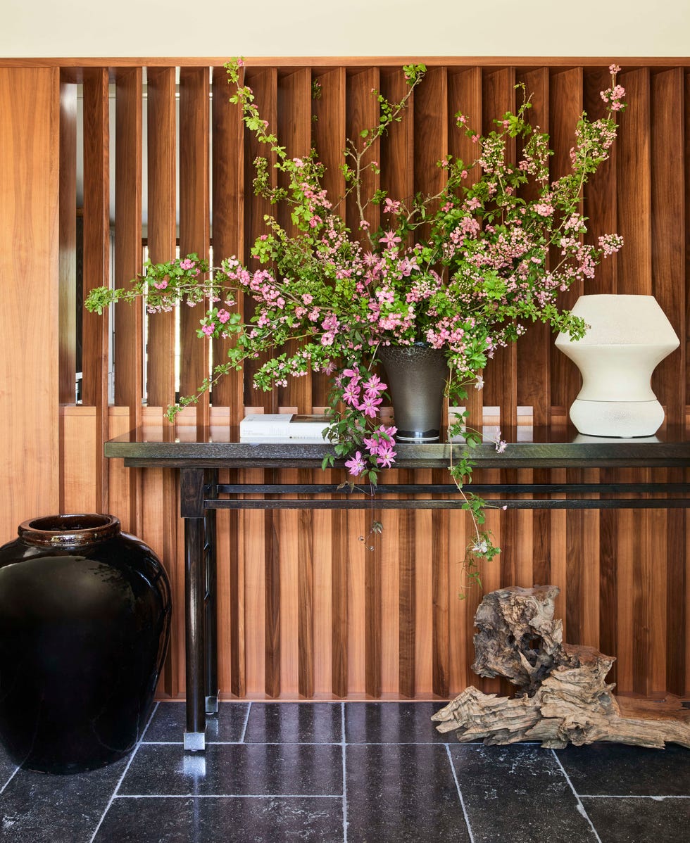 a new slatted walnut screen separates the entry hall from the kitchen