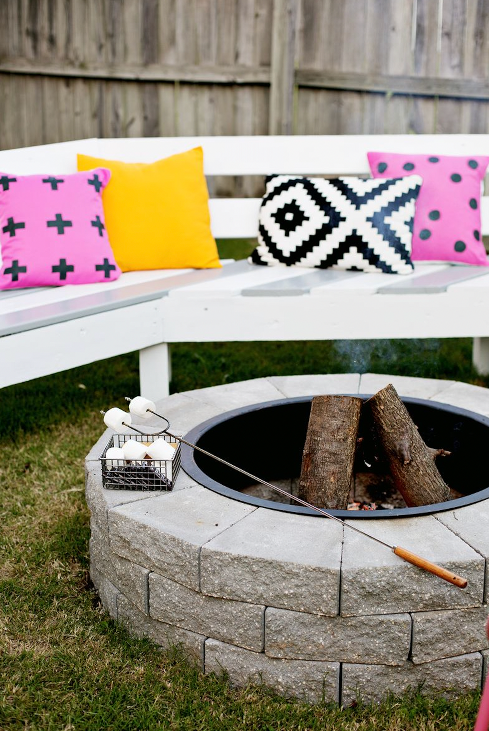 A fire pit with colorful pillows