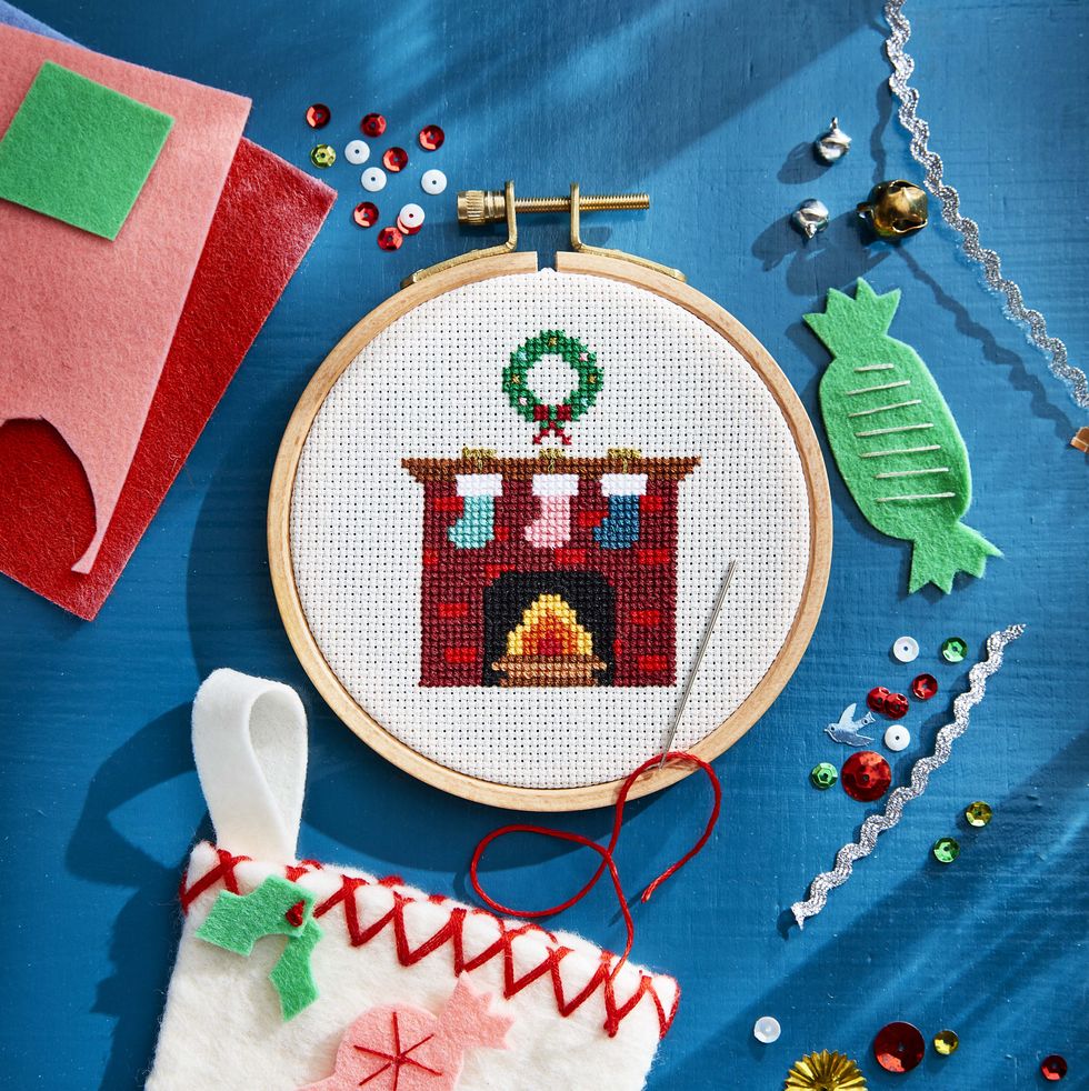 cross stitch fireplace with wreath and stockings