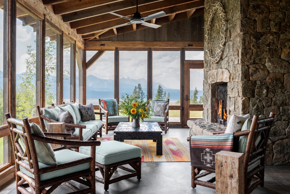 stone fireplace on a screened in porch