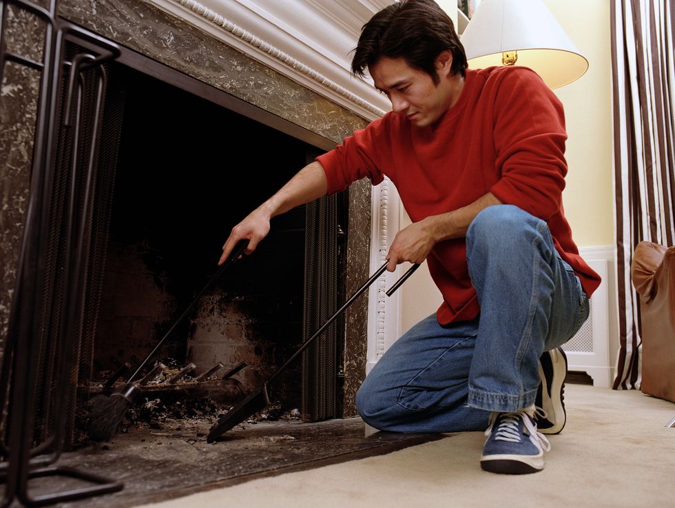 man cleaning out fireplace