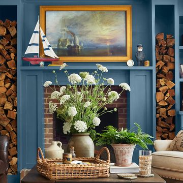 blue living room with matching mantel and built in storage framing a brick fireplace