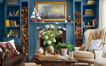 blue living room with matching mantel and built in storage framing a brick fireplace