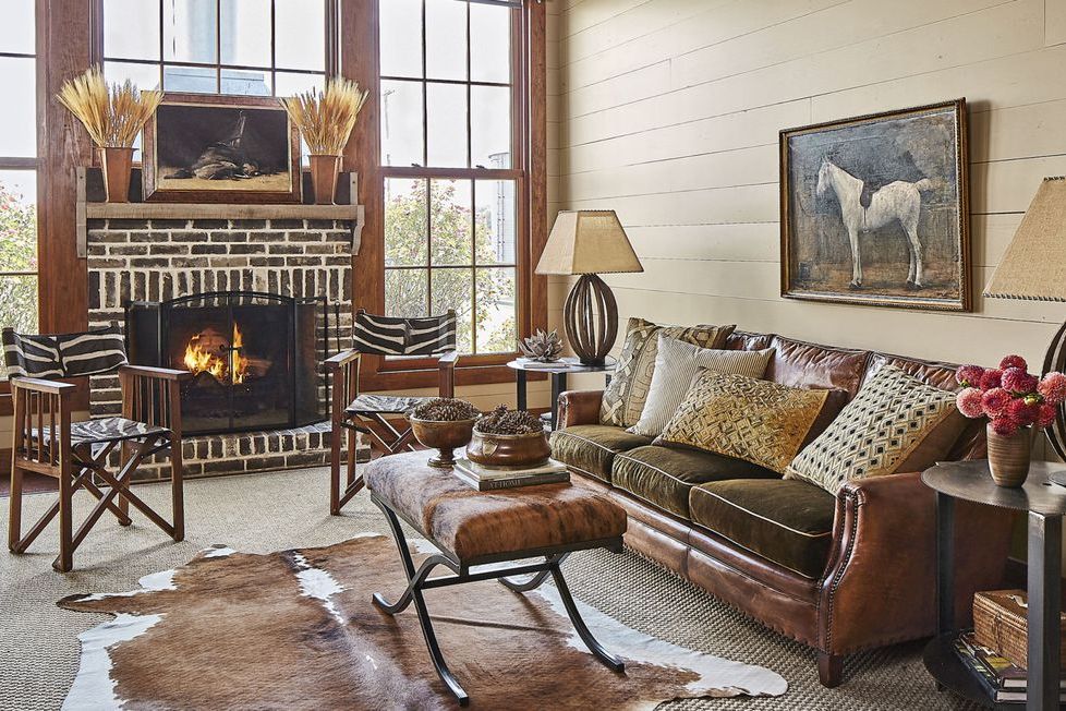 fireplace mantel with brick and a leather sofa