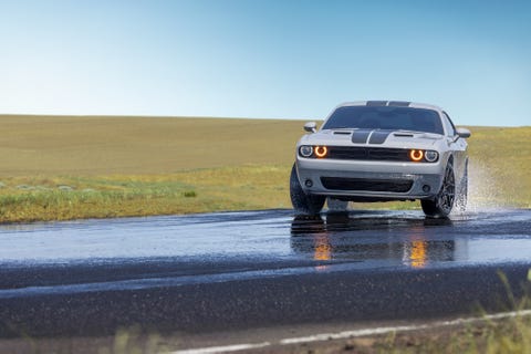 car driving on wet track with firestone firehawk all season tires