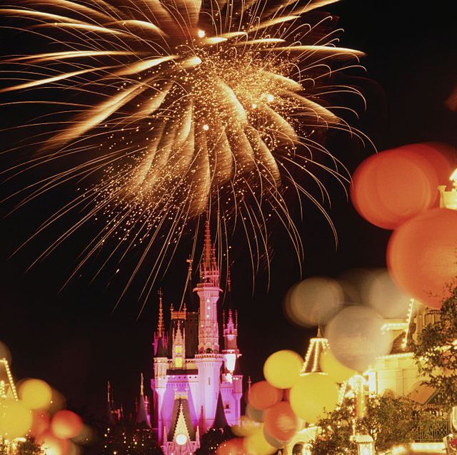 disney world anniversary with balloons and fireworks at night