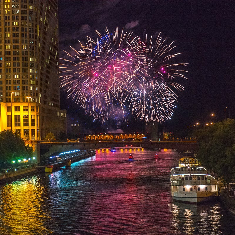 red white and blue fireworks over chicago navy pier and chicago river