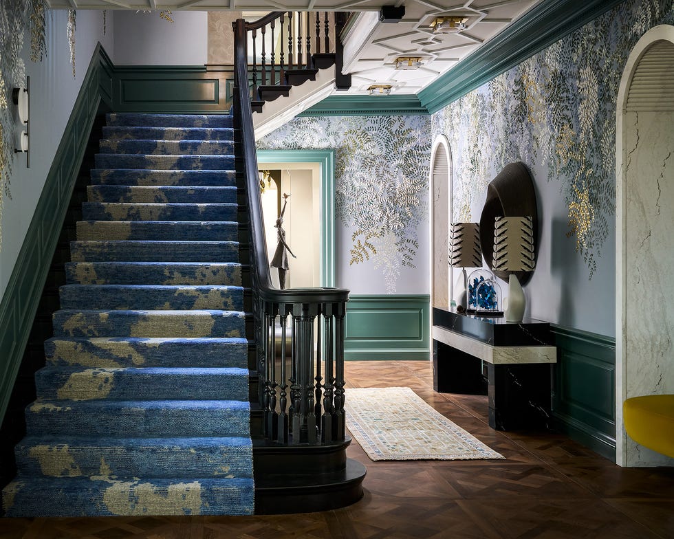 hallway and staircase with a hand embroidered tree wallcovering