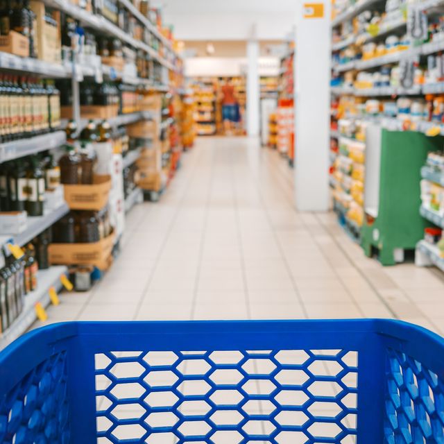 first person view of a shopping cart in the aisle of a supermarket.