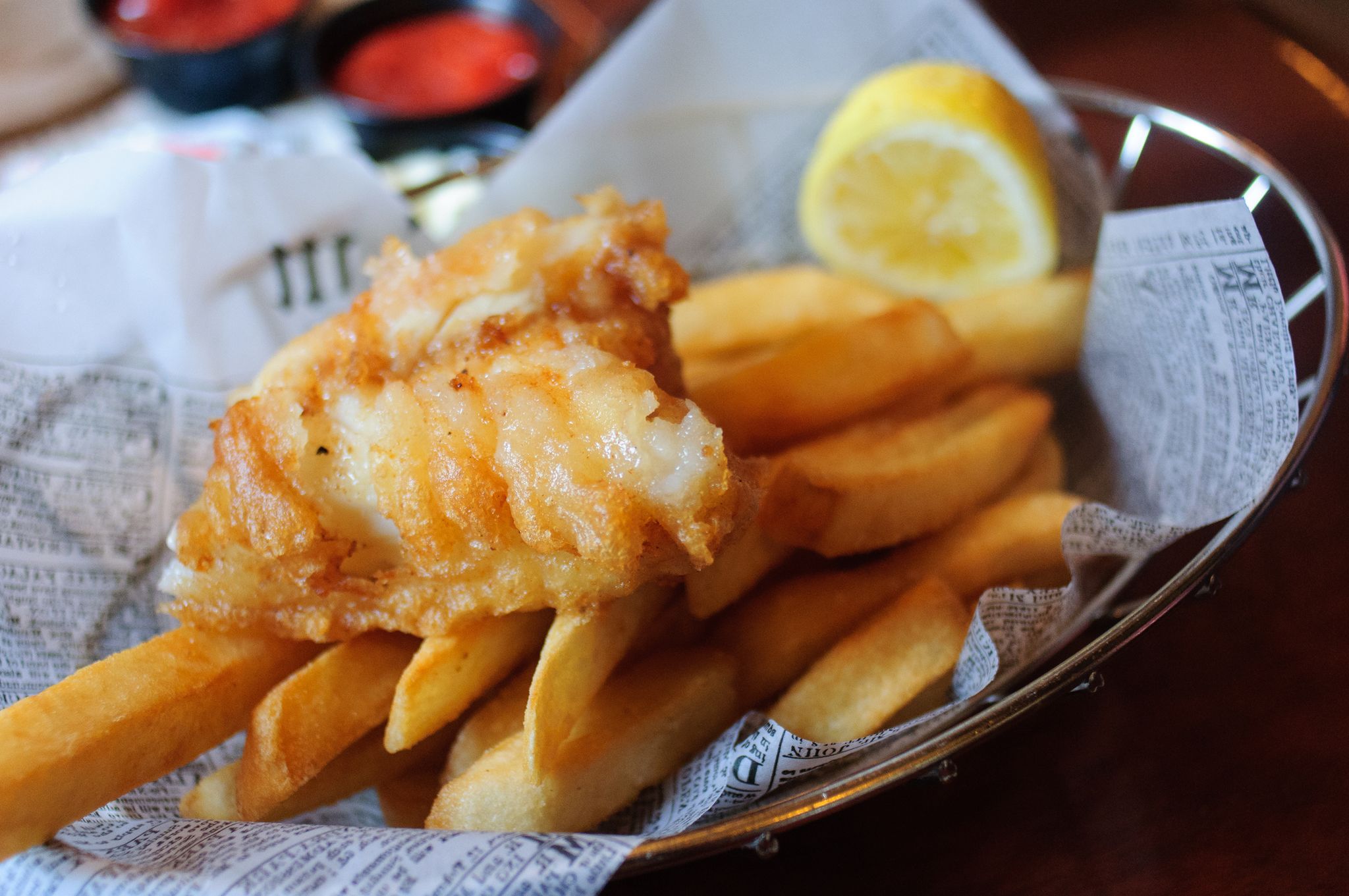 Fish and chips in a basket with a lemon