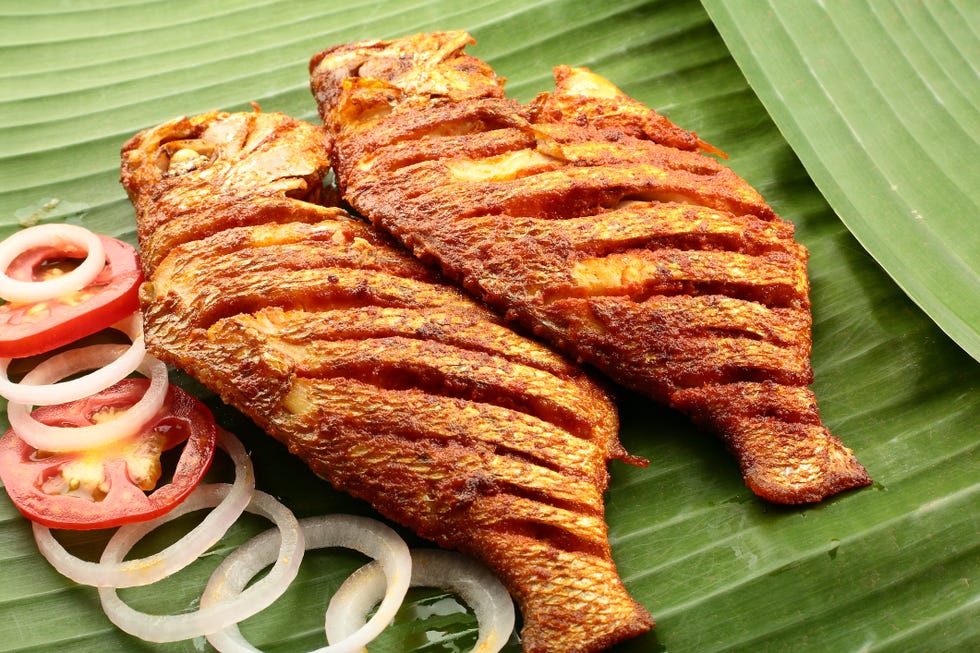 fish fry served on banana leaf,